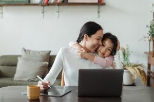 young girl embracing her mother